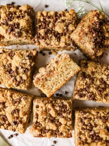 Overhead view of a banana coffee cake that's been removed from the pan and cut into square pieces.