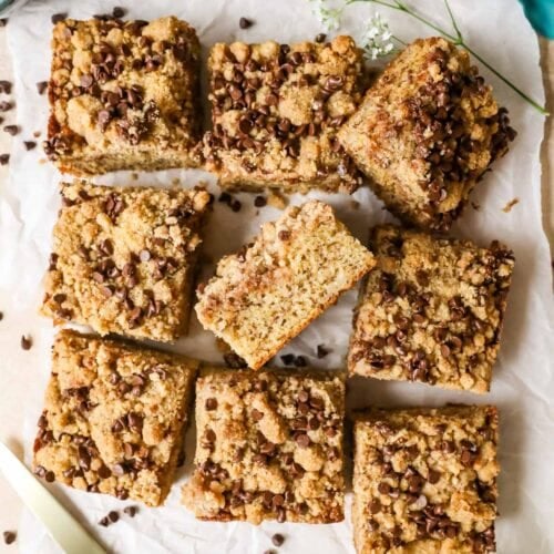 Overhead view of a banana coffee cake that's been removed from the pan and cut into square pieces.