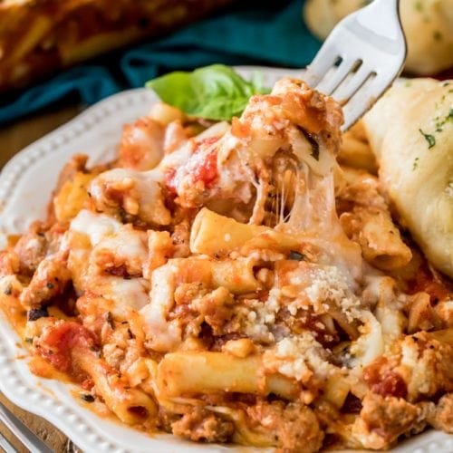 Fork lifting baked ziti off plate