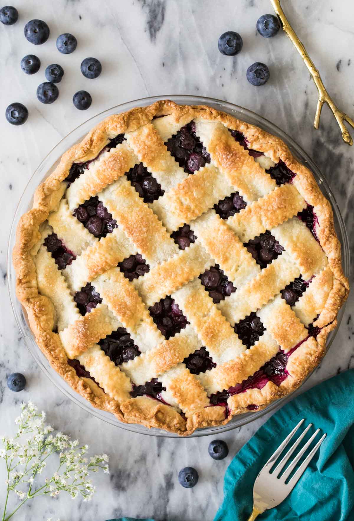 Overhead view of a berry pie with a baked lattice crust.