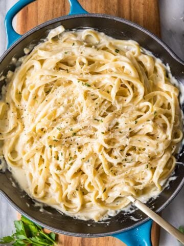 Overhead view of a skillet of fettuccine alfredo.