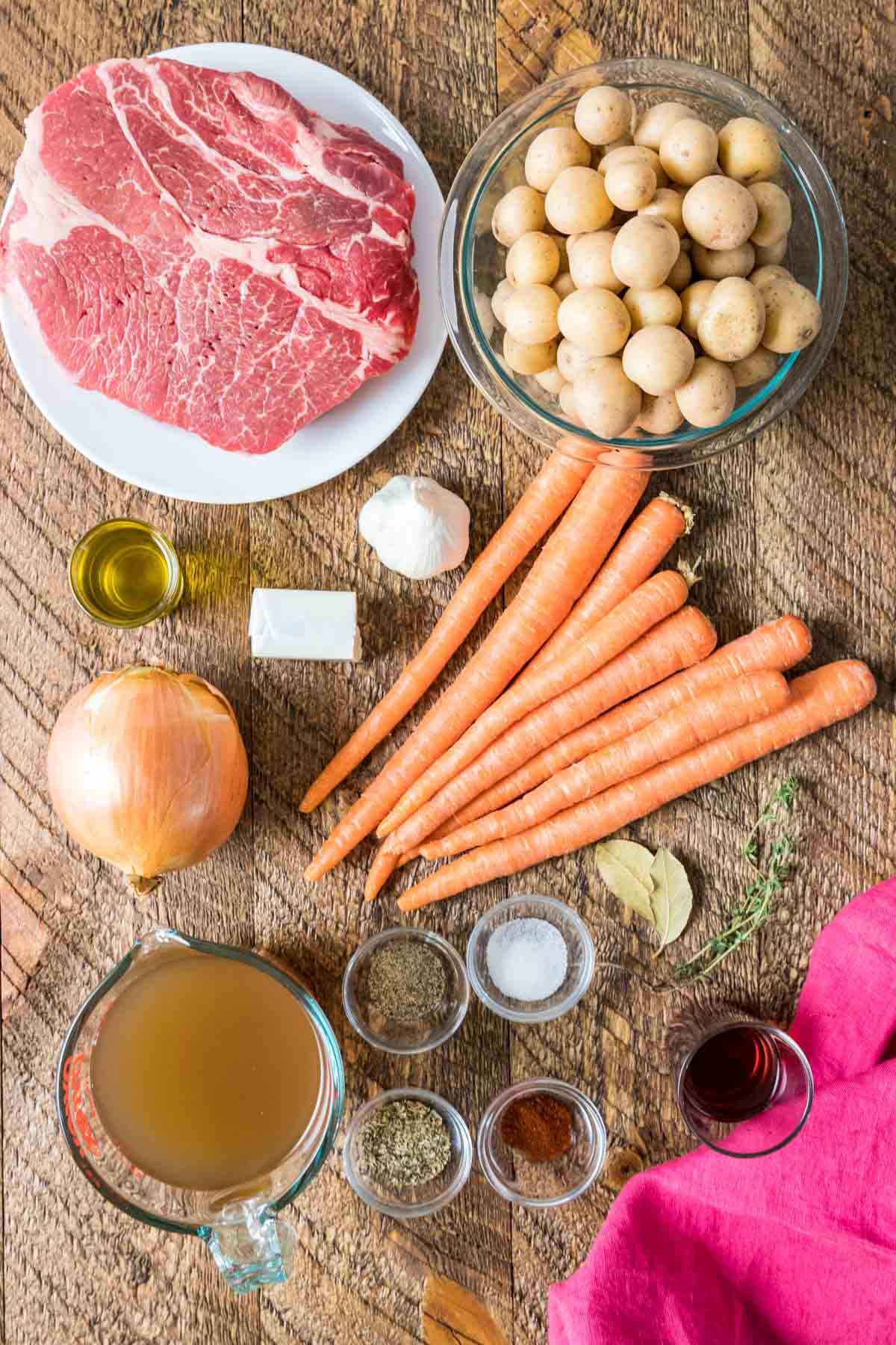 Overhead view of ingredients including beef, carrots, potatoes, and more.
