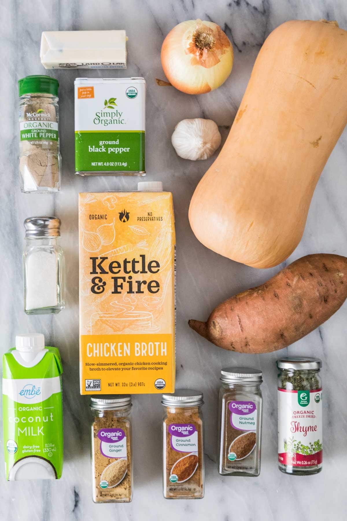 Overhead view of ingredients including butternut squash, coconut milk, sweet potato, spices, and more.