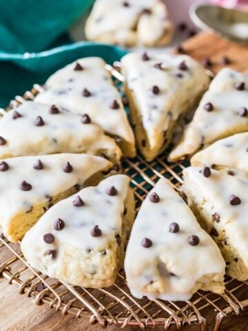Triangular chocolate chip scones arranged in a circle on a cooling rack.