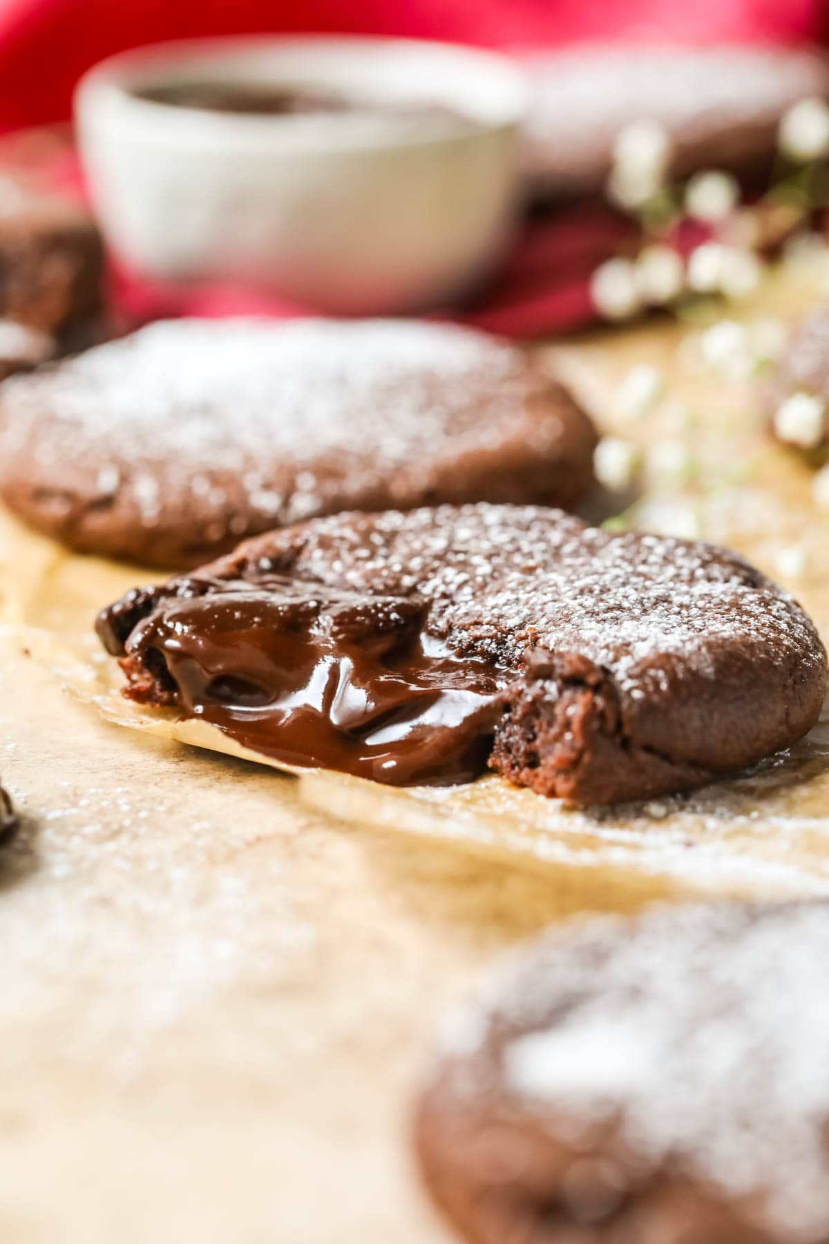 Chocolate lava cookie that's been bitten to show the molten chocolate center.