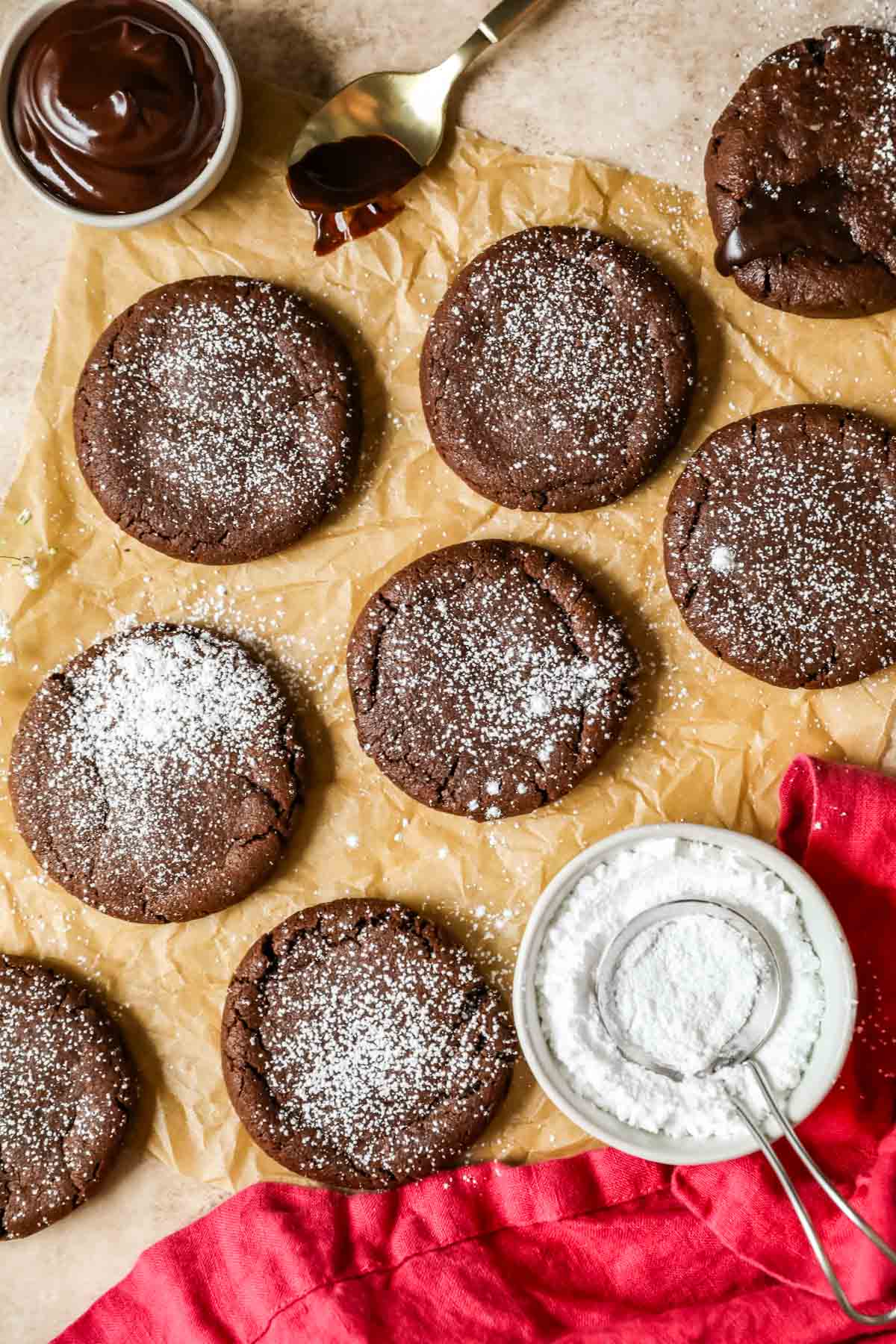 Overhead view of chocolate cookies that have been dusted with powdered sugar.