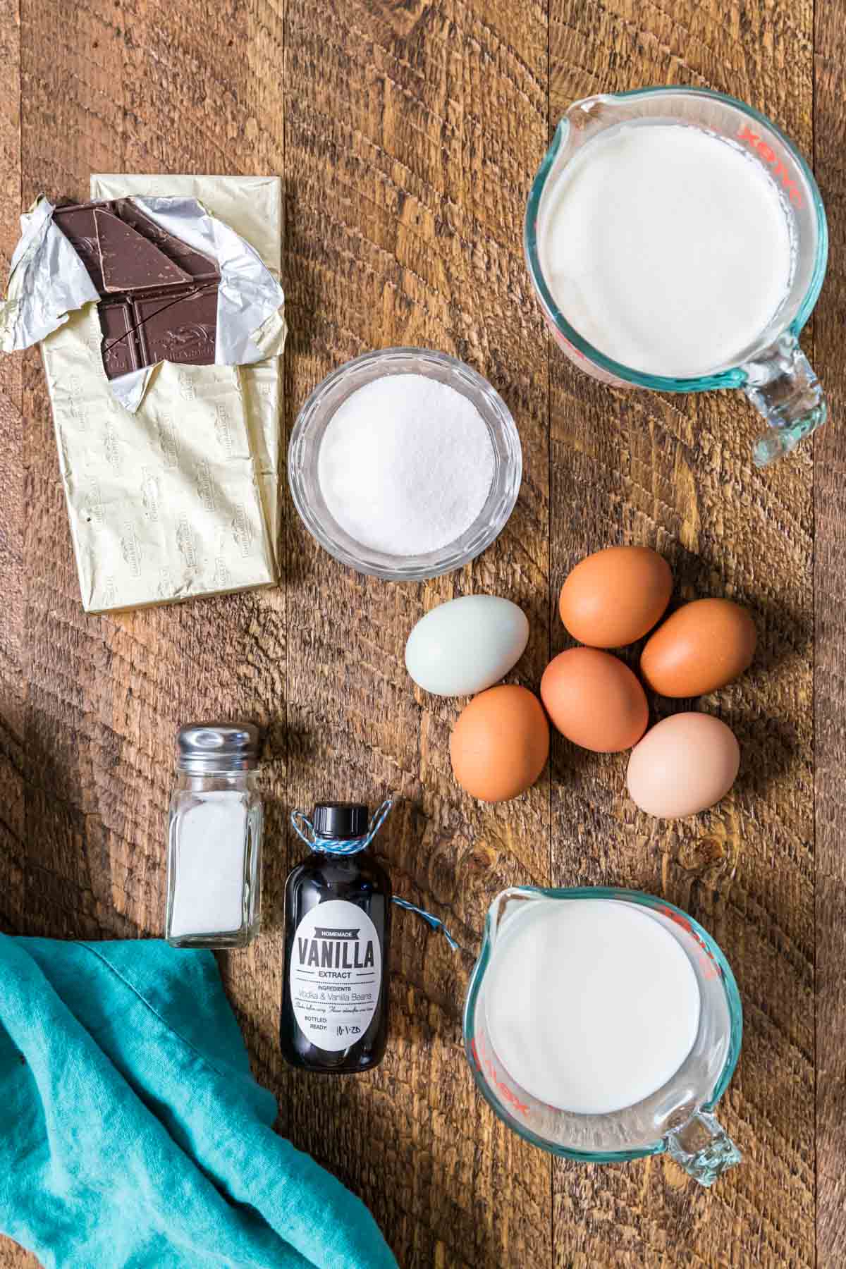 Overhead view of ingredients including chocolate, eggs, cream, and more.
