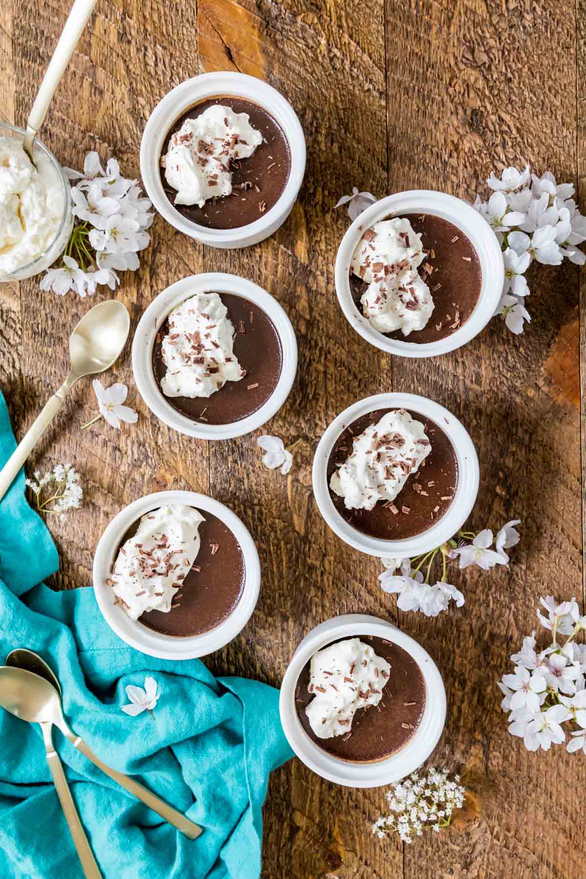Overhead view of chocolate pot de creme in small white ramekins.