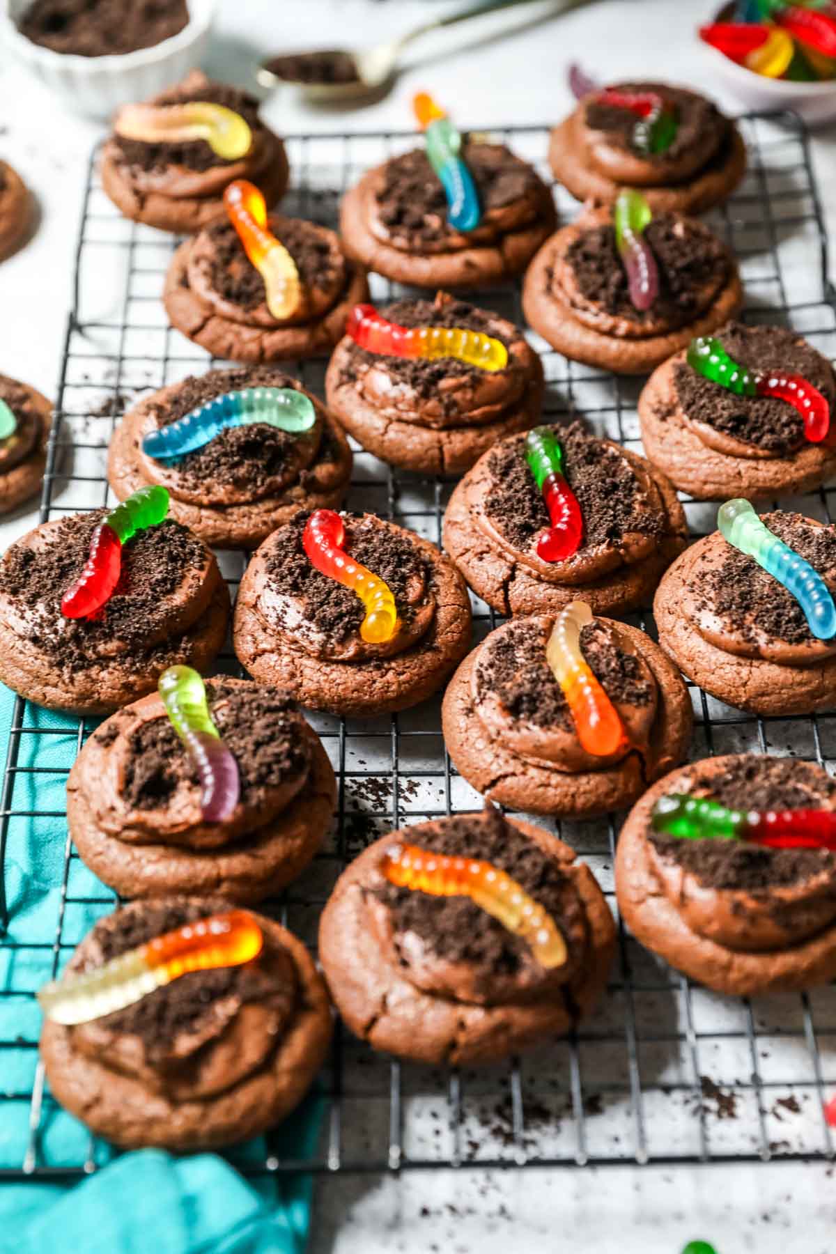 Cooling rack of dirt cookies topped with gummy worms.