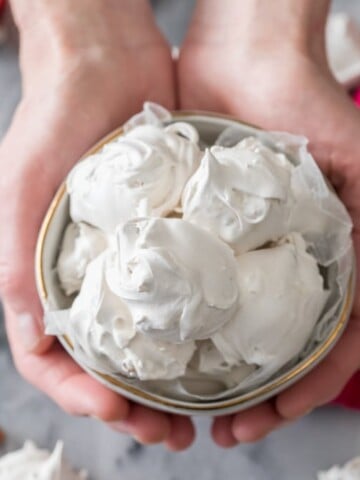 Hands holding seafoam in bowl