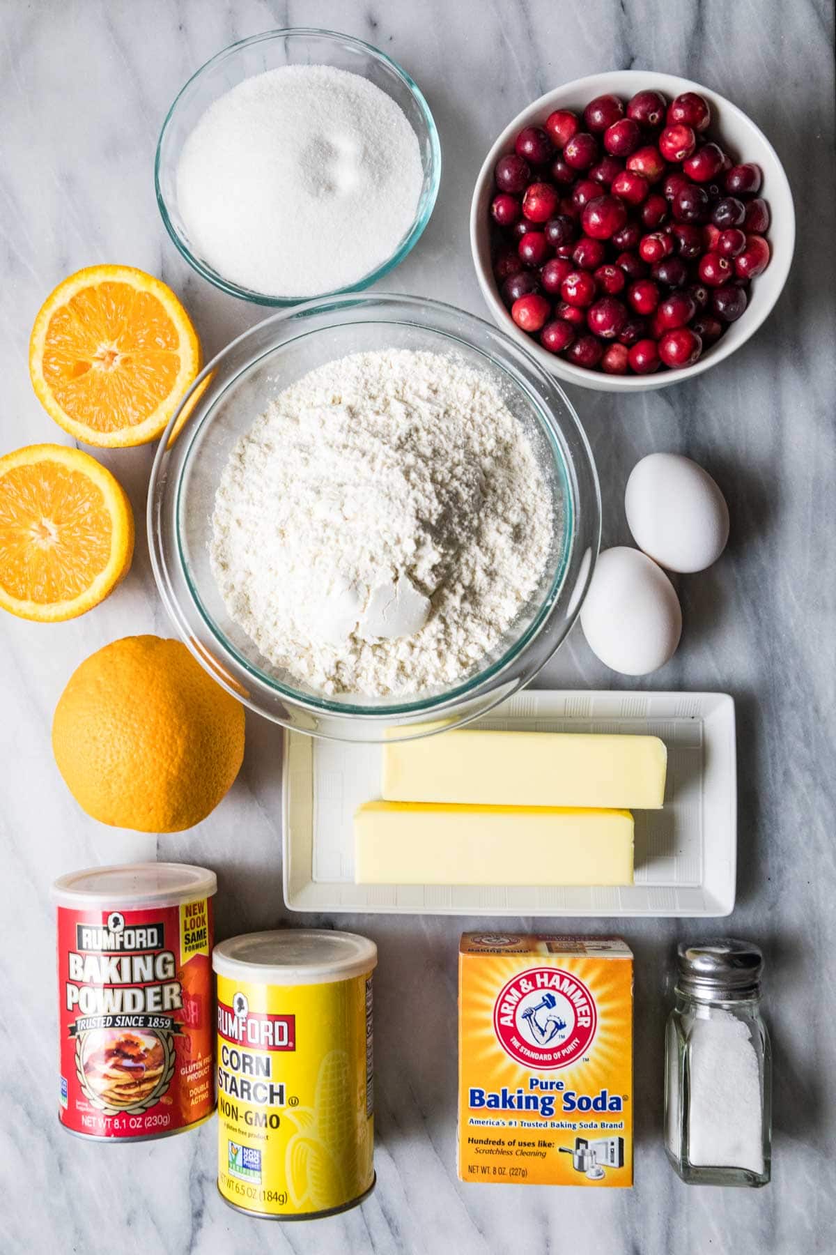 Overhead view of ingredients including oranges, cranberries, butter, and more.