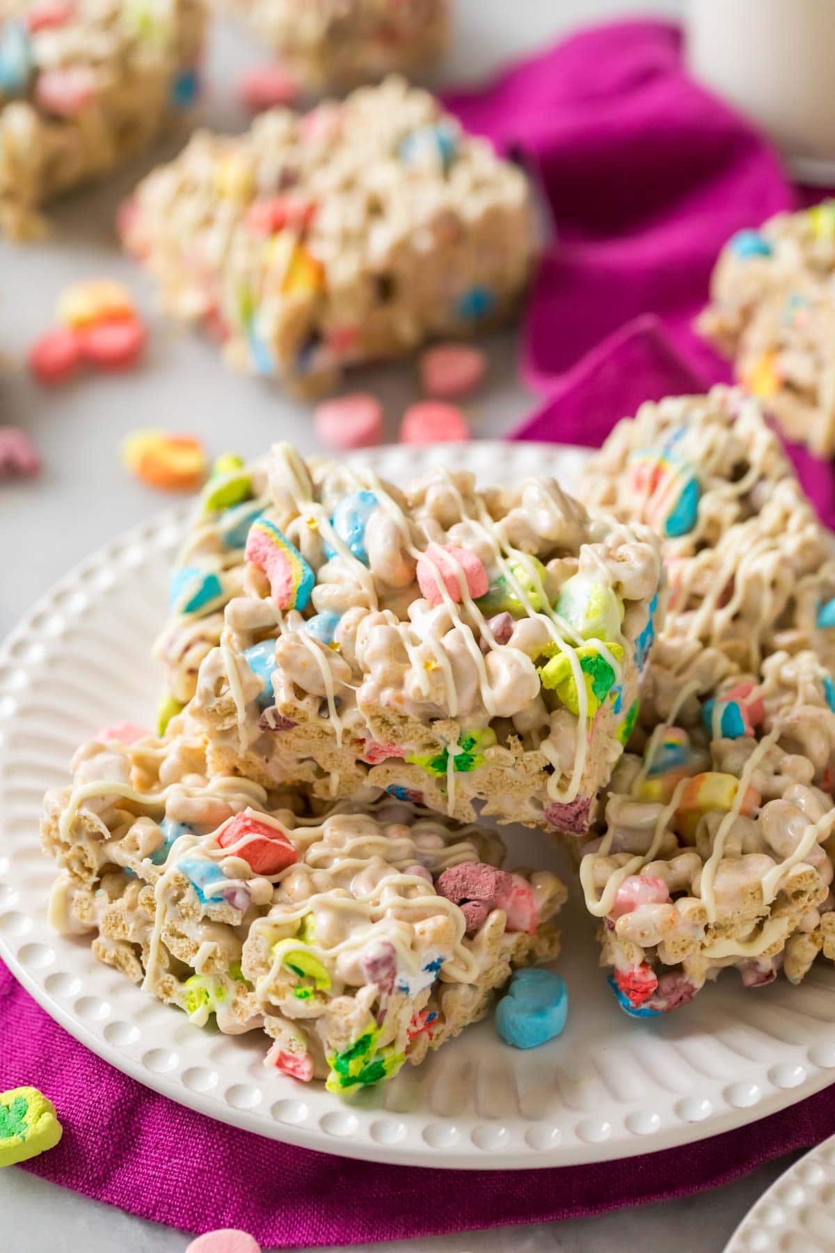 Plate of cereal bars made with Lucky Charms cereal.