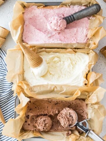 overhead view of three flavors of no churn ice cream including strawberry, vanilla, and chocolate
