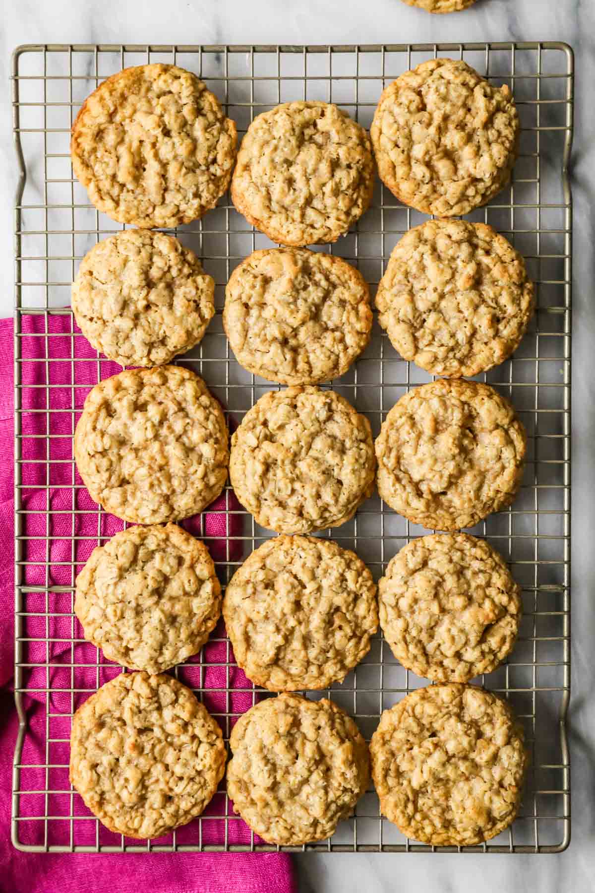 Overhead view of oatmeal cookies cooling on a cooking rack