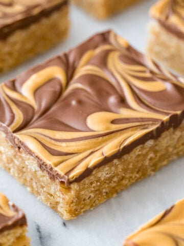 neatly cut scotcharoos with a swirled chocolate and butterscotch topping