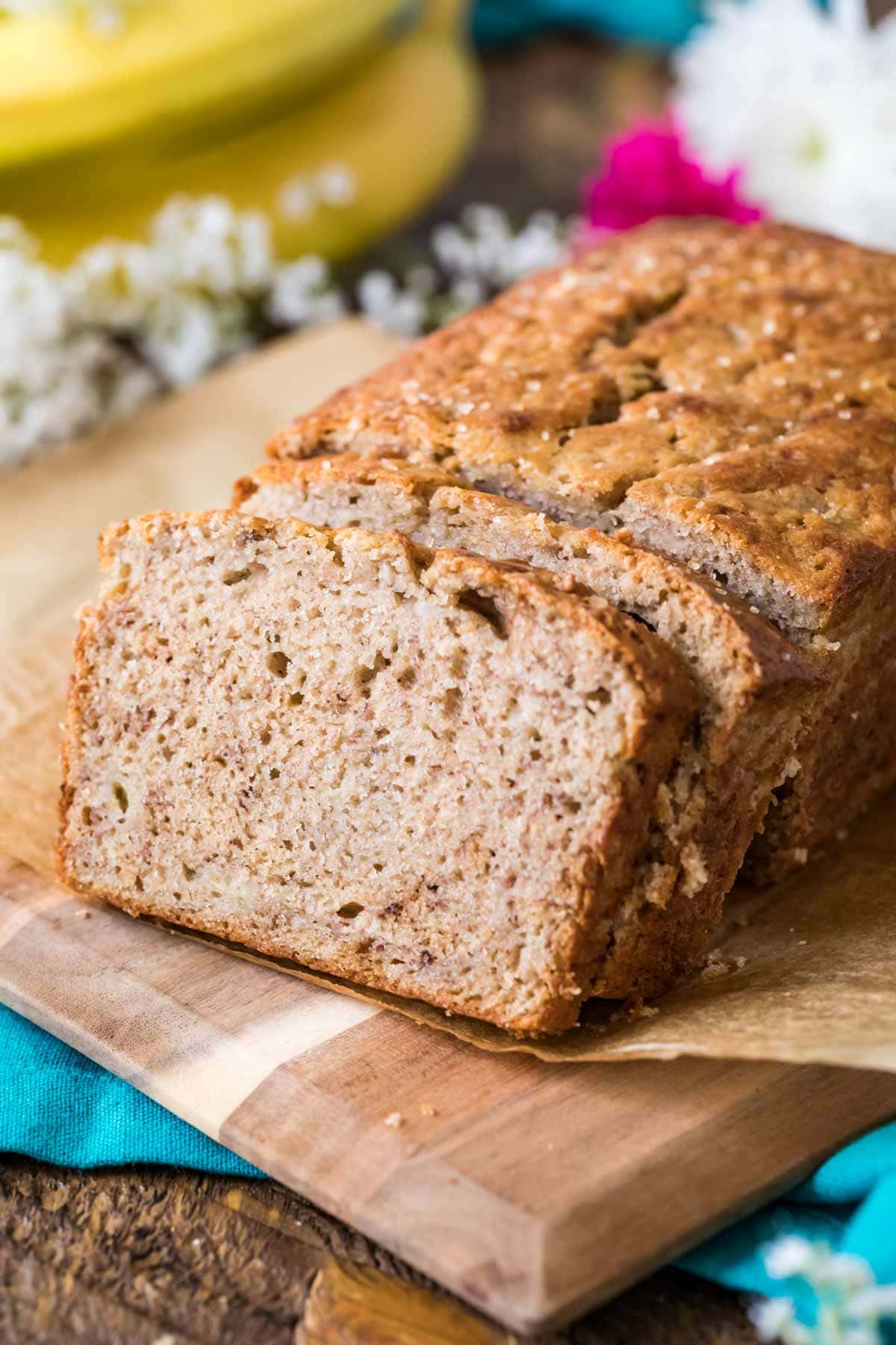 Slices of sourdough banana bread stacked against the remaining loaf.