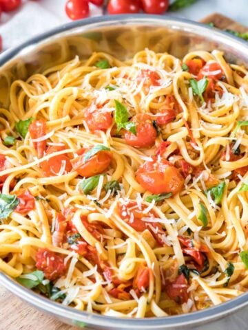 summer pasta with fresh cherry tomatoes and basil served in a skillet